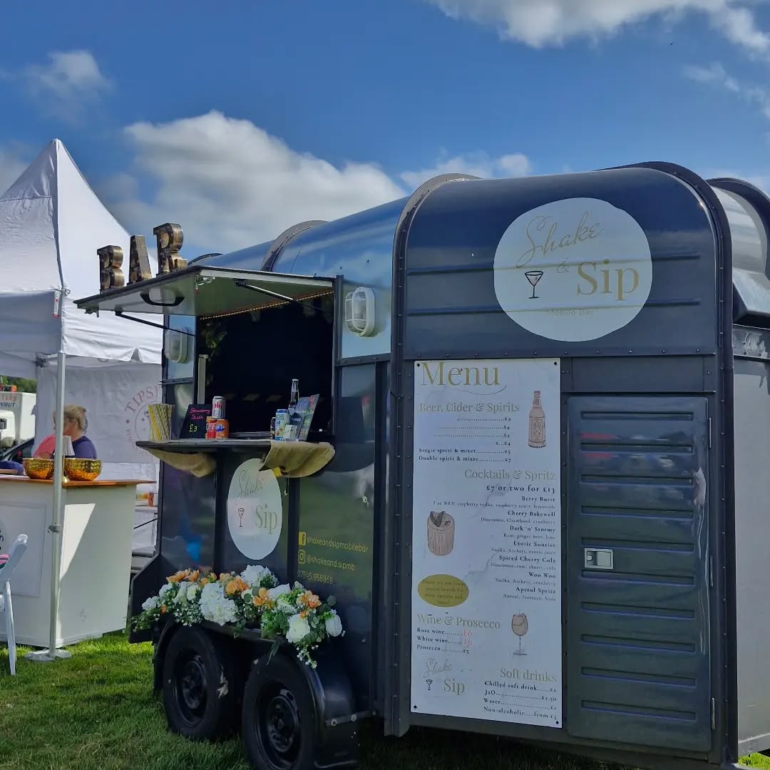 Shake & Sip converted horsebox mobile bar decorated with flowers at a wedding